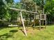 Backyard featuring a playset with swings, a climbing area, and other fun features at 100 Michaels Way, Chapel Hill, NC 27516