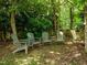 An outdoor lounge area with a serene wooded backdrop provides a peaceful retreat at 100 Michaels Way, Chapel Hill, NC 27516