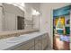 Bathroom featuring a double vanity and a peek into an adjacent blue-themed bedroom at 100 Michaels Way, Chapel Hill, NC 27516