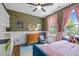 Stylized bedroom featuring decorative wallpaper, pink curtains, a wooden dresser and hardwood floors at 100 Michaels Way, Chapel Hill, NC 27516