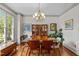 Dining room featuring hardwood floors, a large window, modern light fixture, and elegant design at 100 Michaels Way, Chapel Hill, NC 27516