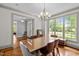 Dining room with hardwood floors, large windows, and modern lighting creates an elegant entertaining space at 100 Michaels Way, Chapel Hill, NC 27516