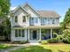 Charming two-story home featuring a welcoming front porch and beautifully landscaped front yard under a clear blue sky at 100 Michaels Way, Chapel Hill, NC 27516