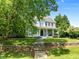 Charming two-story home with a manicured front lawn, stone steps, and a welcoming porch at 100 Michaels Way, Chapel Hill, NC 27516