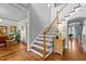 Foyer with hardwood floors, staircase, and view into the dining room showcasing an open floor plan at 100 Michaels Way, Chapel Hill, NC 27516