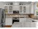 Kitchen with white cabinets, granite countertops, stainless-steel appliances, and glass-front cabinets at 100 Michaels Way, Chapel Hill, NC 27516