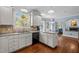 Bright kitchen with white cabinets, granite counters, and a stained-glass window adds a touch of artistry at 100 Michaels Way, Chapel Hill, NC 27516