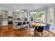 Spacious kitchen featuring white cabinetry, granite countertops, stainless steel appliances, and a breakfast bar at 100 Michaels Way, Chapel Hill, NC 27516