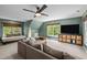 Spacious living room with a ceiling fan, comfortable seating, and large windows providing ample natural light at 100 Michaels Way, Chapel Hill, NC 27516
