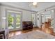 Living room with hardwood floors, a piano, and access to outdoor seating offering versatile living space at 100 Michaels Way, Chapel Hill, NC 27516