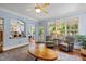 Bright living room showing hardwood floors, a fireplace, and access to the porch, creating a seamless indoor-outdoor flow at 100 Michaels Way, Chapel Hill, NC 27516