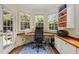 Bright office space with built-in desk and cabinets, offering natural light and outdoor views at 100 Michaels Way, Chapel Hill, NC 27516