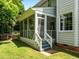 Rear view of a home showing a delightful screened porch that opens to a grassy yard at 100 Michaels Way, Chapel Hill, NC 27516