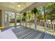 Charming screened porch with a striped rug, backyard view, and comfortable furniture at 100 Michaels Way, Chapel Hill, NC 27516
