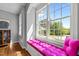 Cozy window seat with bright pink cushions and large windows offering natural light and neighborhood views at 100 Michaels Way, Chapel Hill, NC 27516