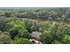 Aerial view of the home nestled among trees and overlooking the lake at 1009 Bearglades Ln, Raleigh, NC 27615
