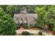 Aerial view of the stunning home with a mature tree surround near a lake at 1009 Bearglades Ln, Raleigh, NC 27615