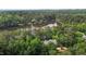 Aerial view of the home and surrounding landscape, showcasing the lake at 1009 Bearglades Ln, Raleigh, NC 27615