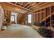 Unfinished attic space with exposed wood framework and windows showing potential for customization and ample storage at 1009 Bearglades Ln, Raleigh, NC 27615