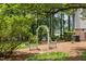 Charming backyard garden with a white archway and lush landscaping at 1009 Bearglades Ln, Raleigh, NC 27615