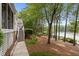 Beautiful backyard with a view of the lake, landscaped with grass and trees at 1009 Bearglades Ln, Raleigh, NC 27615