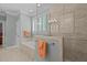 Well-lit bathroom features tiled floors, a bathtub, a glass-enclosed shower and neutral walls at 1009 Bearglades Ln, Raleigh, NC 27615