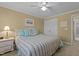 Bedroom with bed and white ceiling fan, light yellow walls and carpet at 1009 Bearglades Ln, Raleigh, NC 27615