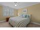 Bedroom with bed and window, light yellow walls and carpet at 1009 Bearglades Ln, Raleigh, NC 27615