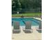Close-up view of community pool with chairs and lane markers for swimming at 1009 Bearglades Ln, Raleigh, NC 27615