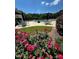 Community pool area with lounge chairs and tables, surrounded by roses and landscaping at 1009 Bearglades Ln, Raleigh, NC 27615
