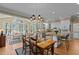 Bright dining area with a modern chandelier, a breakfast bar and open floor plan into the kitchen and living room at 1009 Bearglades Ln, Raleigh, NC 27615