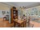 Open concept living area with a dining table and views into the living room and the natural landscape at 1009 Bearglades Ln, Raleigh, NC 27615