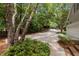 Long driveway leading to this property, surrounded by mature trees and landscaping at 1009 Bearglades Ln, Raleigh, NC 27615
