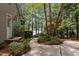 Beautiful view of the home from the backyard and lake, surrounded by trees and landscaping at 1009 Bearglades Ln, Raleigh, NC 27615