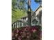 Charming home exterior featuring large arched windows and vibrant pink rhododendrons at 1009 Bearglades Ln, Raleigh, NC 27615