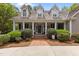 Inviting front entrance with a classic door, brick steps, and lush landscaping for a welcoming appeal at 1009 Bearglades Ln, Raleigh, NC 27615