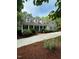 Inviting home exterior with manicured lawn, mature trees, and a paved driveway at 1009 Bearglades Ln, Raleigh, NC 27615