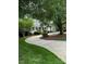 Well-maintained home with a curving driveway and lush landscaping in a serene setting at 1009 Bearglades Ln, Raleigh, NC 27615