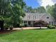 Charming home with dormer windows, a covered porch, and mature landscaping at 1009 Bearglades Ln, Raleigh, NC 27615