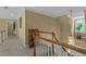 Hallway with staircase, wooden railing and light-colored walls and carpets at 1009 Bearglades Ln, Raleigh, NC 27615