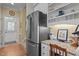 Kitchen area featuring stainless steel refrigerator, granite countertops, and a built-in desk space with ample storage at 1009 Bearglades Ln, Raleigh, NC 27615