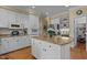 Spacious kitchen with granite island, white cabinets, stainless steel appliances, and convenient layout for cooking at 1009 Bearglades Ln, Raleigh, NC 27615