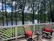 Inviting deck area with comfortable seating and stunning views of the tranquil lake at 1009 Bearglades Ln, Raleigh, NC 27615