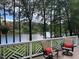 Relaxing deck features comfortable seating and picturesque views of the serene lake at 1009 Bearglades Ln, Raleigh, NC 27615