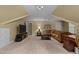 Cozy living room features plush brown sofa, soft carpet, neutral paint, and TV, creating a relaxing retreat at 1009 Bearglades Ln, Raleigh, NC 27615