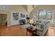 Cozy living room featuring built-in bookshelves, a fireplace, hardwood floors, and comfortable seating at 1009 Bearglades Ln, Raleigh, NC 27615