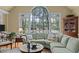 Inviting living room with vaulted ceilings, a large arched window overlooking a scenic view, and comfortable seating at 1009 Bearglades Ln, Raleigh, NC 27615