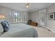 Comfortable main bedroom features neutral walls, white trim, carpet and lake view at 1009 Bearglades Ln, Raleigh, NC 27615