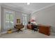 Bright home office featuring hardwood desk, shutters on windows, and neutral walls at 1009 Bearglades Ln, Raleigh, NC 27615