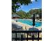 Beautiful community pool surrounded by lounge chairs and umbrellas in a serene setting at 1009 Bearglades Ln, Raleigh, NC 27615